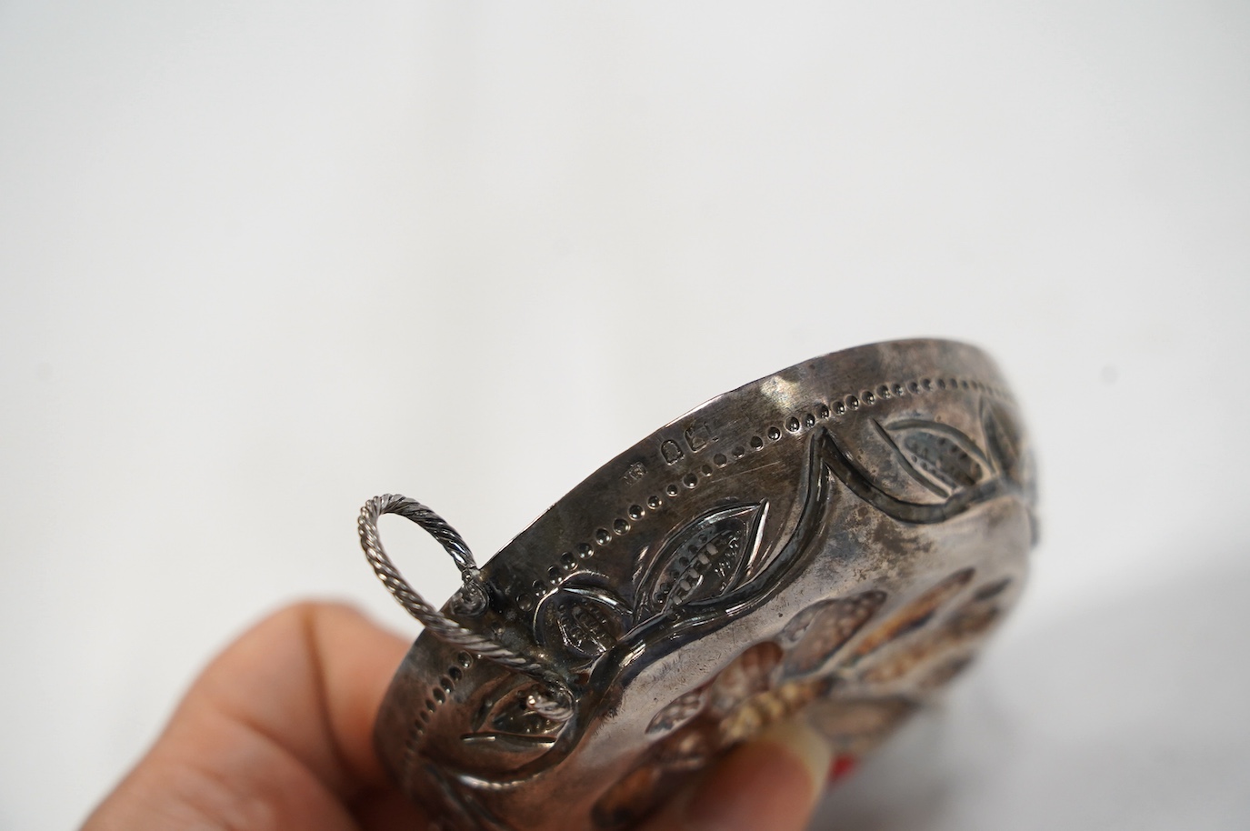 An Edwardian 17th century style Britannia standard silver porringer, by Maurice Freeman, London, circa 1905, 12cm, over handles. Condition - fair